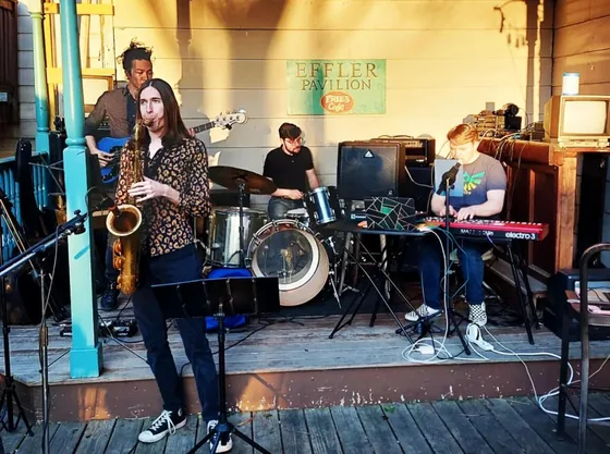 Fast Travel playing a daytime taproom show, full band set up in front of the windows